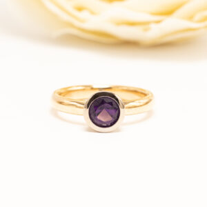 A. Tillander 1996 vintage-sormus. 18k keltakultaa ja 0,90 ct pyöreä viistehiottu ioliitti. Ajaton suomalainen design ja kaunis sinivioletti sävy.